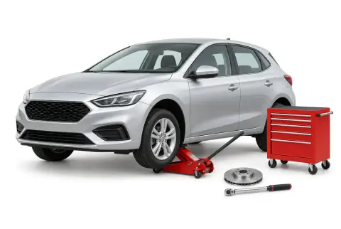 A car on a trolley jack beside a tool chest